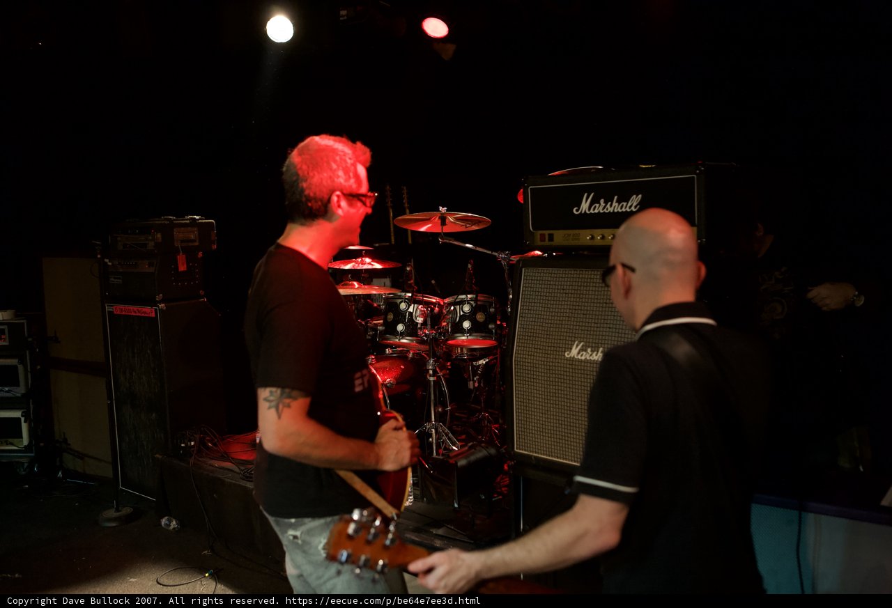 Two Men Rock the Stage with Their Guitars