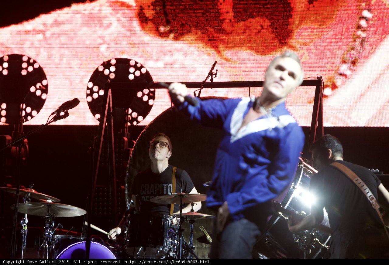 Morrissey Arm Extended Motion Blur Blue Shirt Drummer Glasses Capitol Tee Bassist Two Circular Lights Red Screen