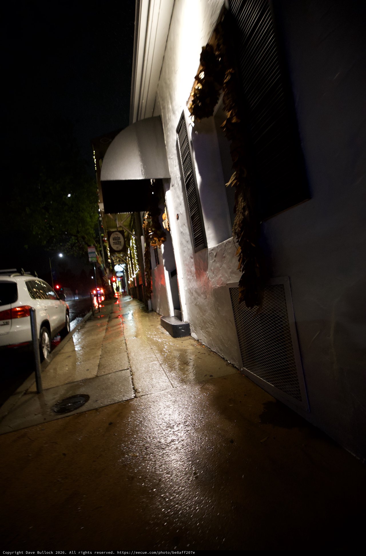 Wet City Street at Night with Holiday Lights