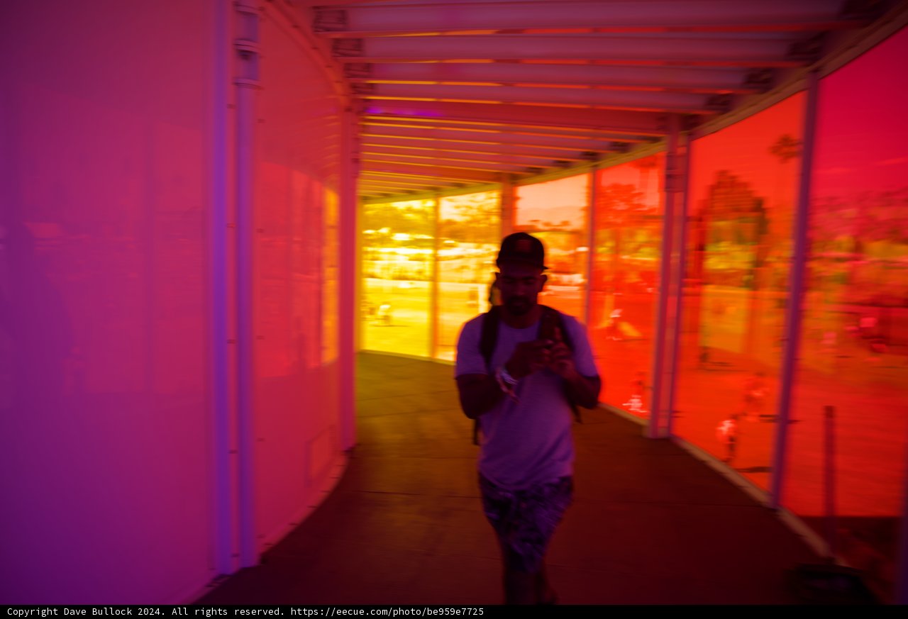 A Colorful Transition: Man Navigating Through Vivid Corridors