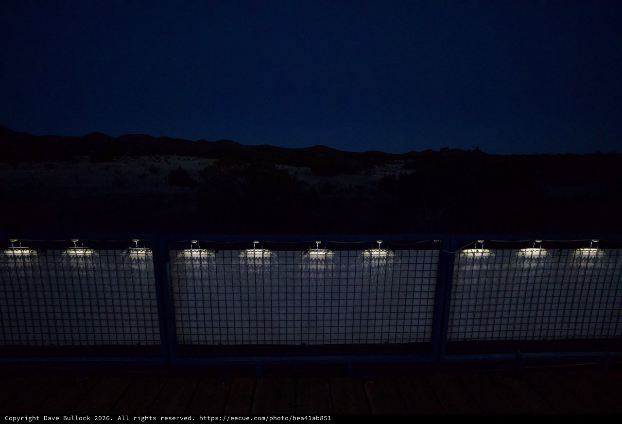 Illuminated Industrial Facility at Twilight in Desert Mountains