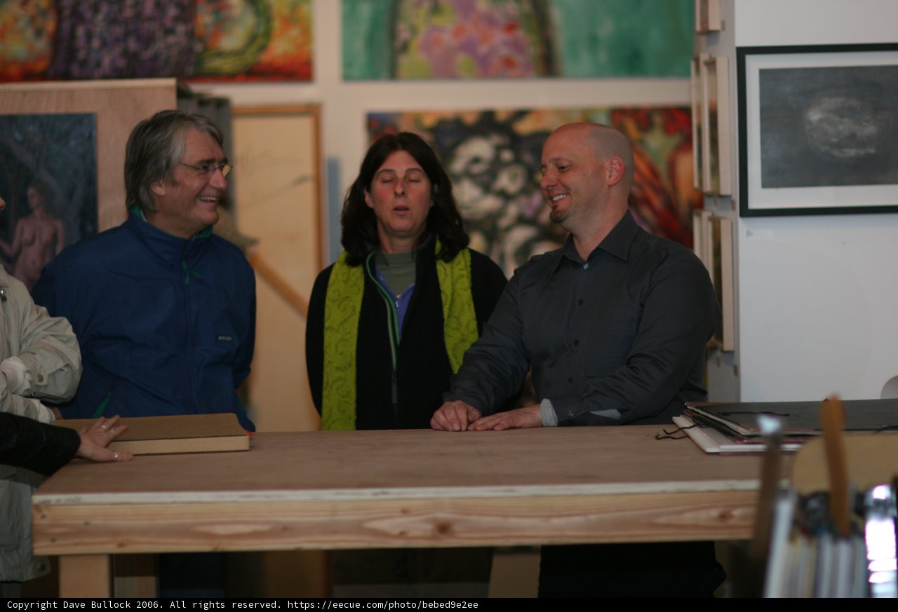 A Trio of Art Lovers in Front of a Plywood Table