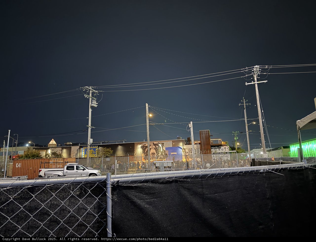 Industrial Night Scene with Power Lines and Graffiti