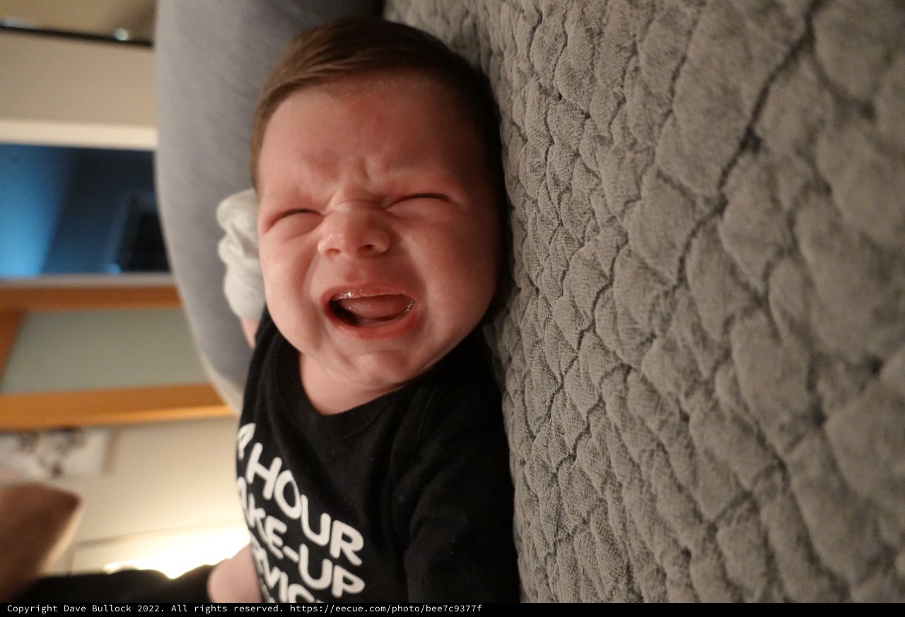 Joyful Baby Laughing on Textured Blanket