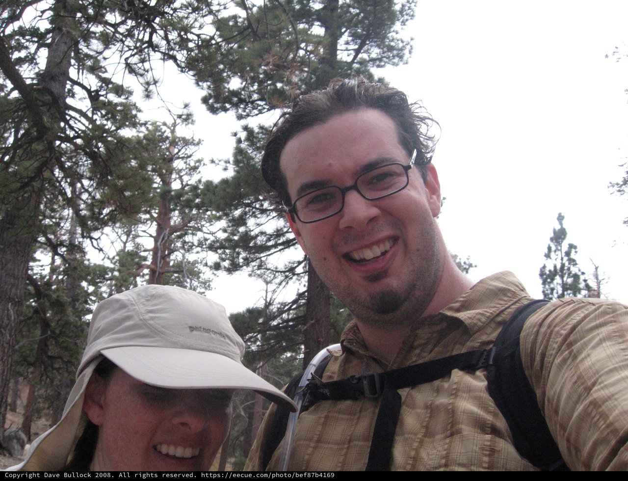 Hikers Selfie Among Pine Trees on Mountain Trail