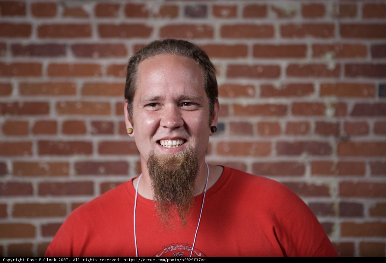 Bearded Man with a Jovial Smile in a Brick Setting