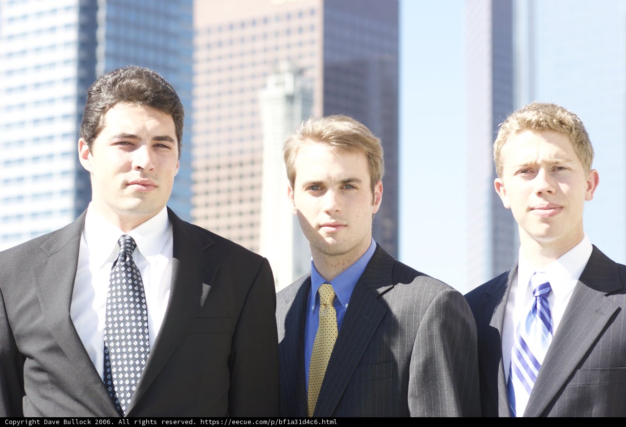Three Men in Suits Striking a Pose