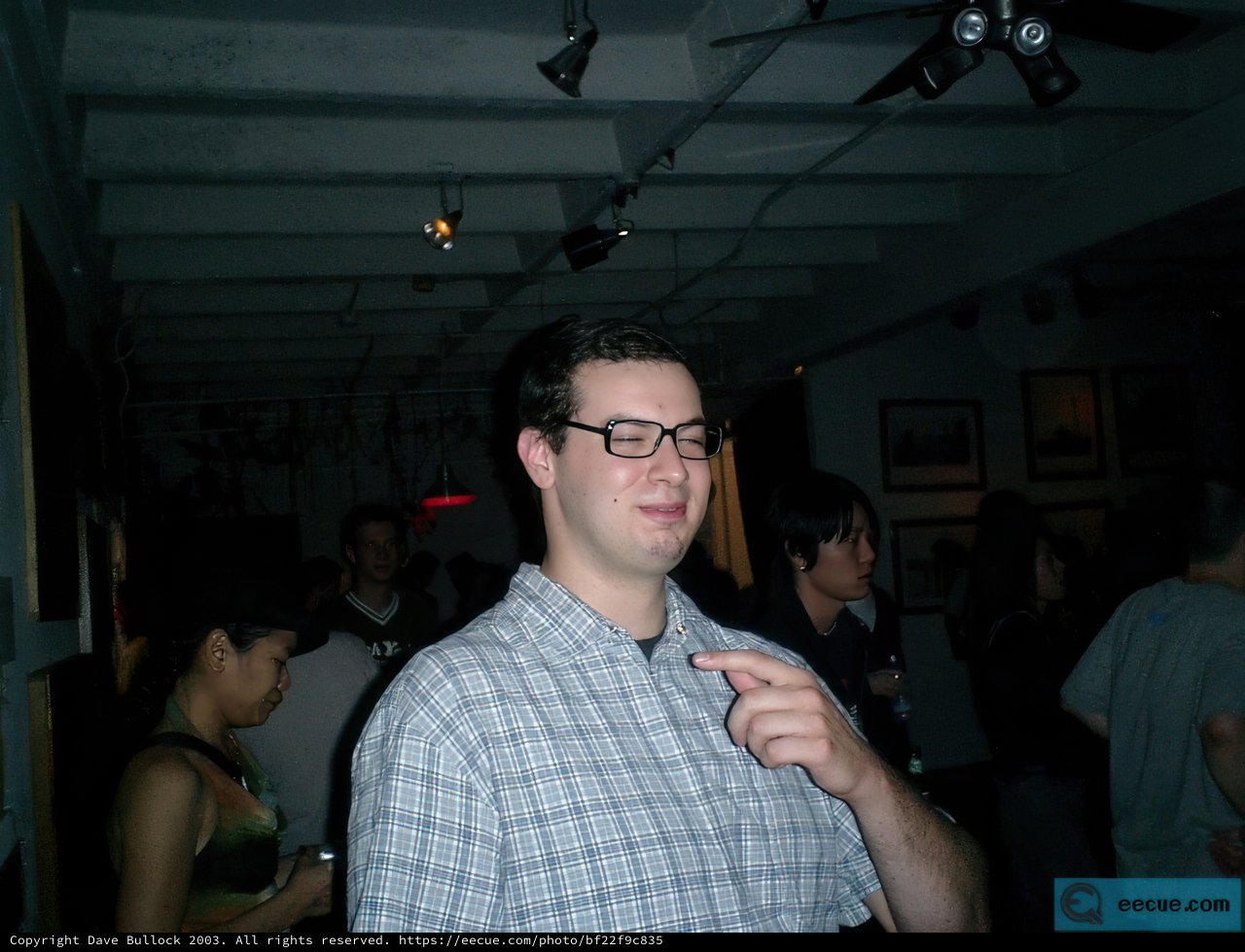 The Glasses-wearing Art Enthusiast in the Urban Night Scene