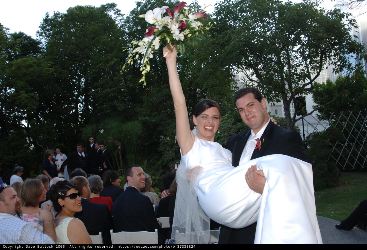 Joyful Bride Lifted by Groom After Wedding Ceremony