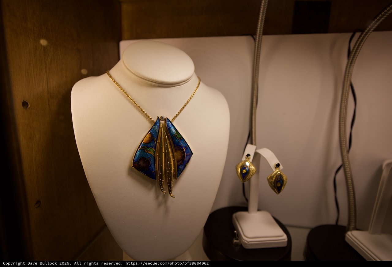 Artisan Jewelry Display with Blue and Gold Pendant