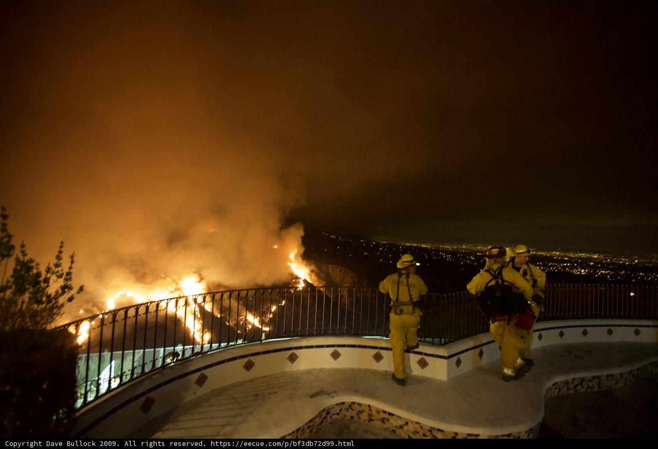 Firefighters Observe the Blaze from the Hillside
