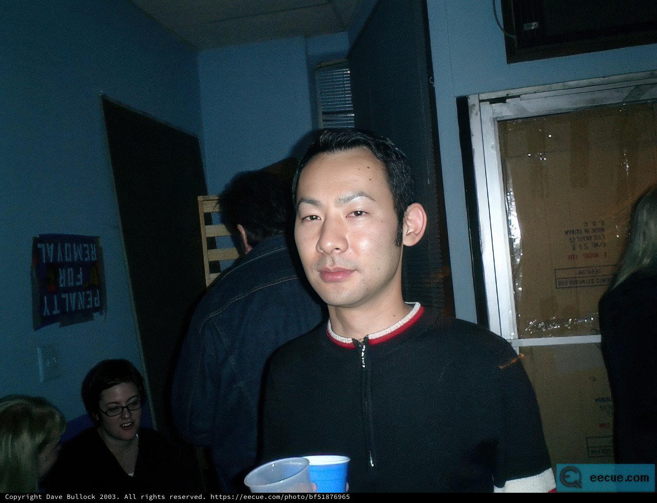 Black shirted man enjoying tea with friends