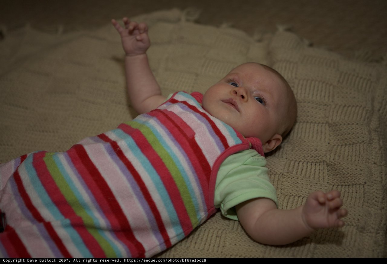 Curious Infant Gazing Upward on Knit Blanket