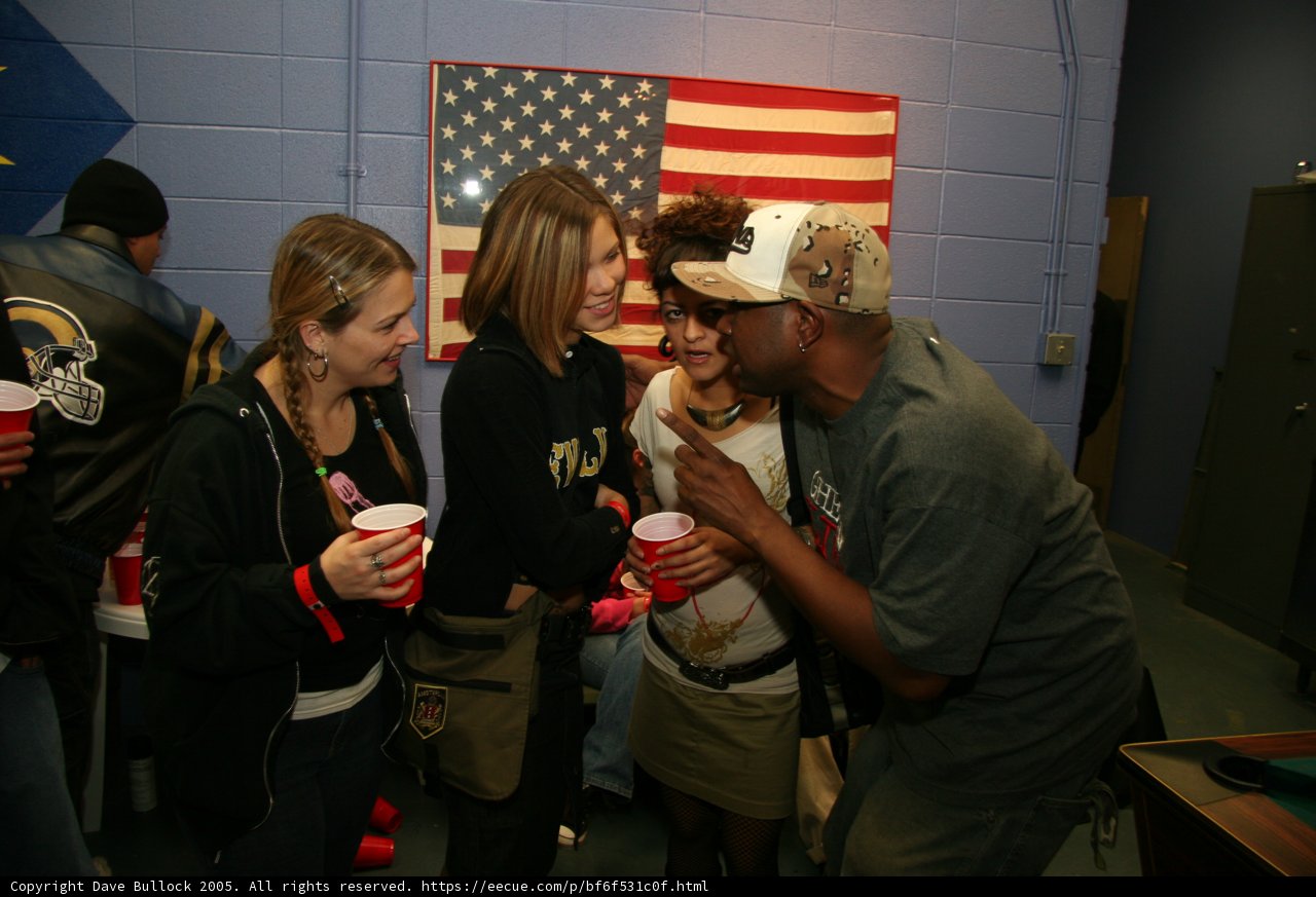 Group discussion with American flag in background.