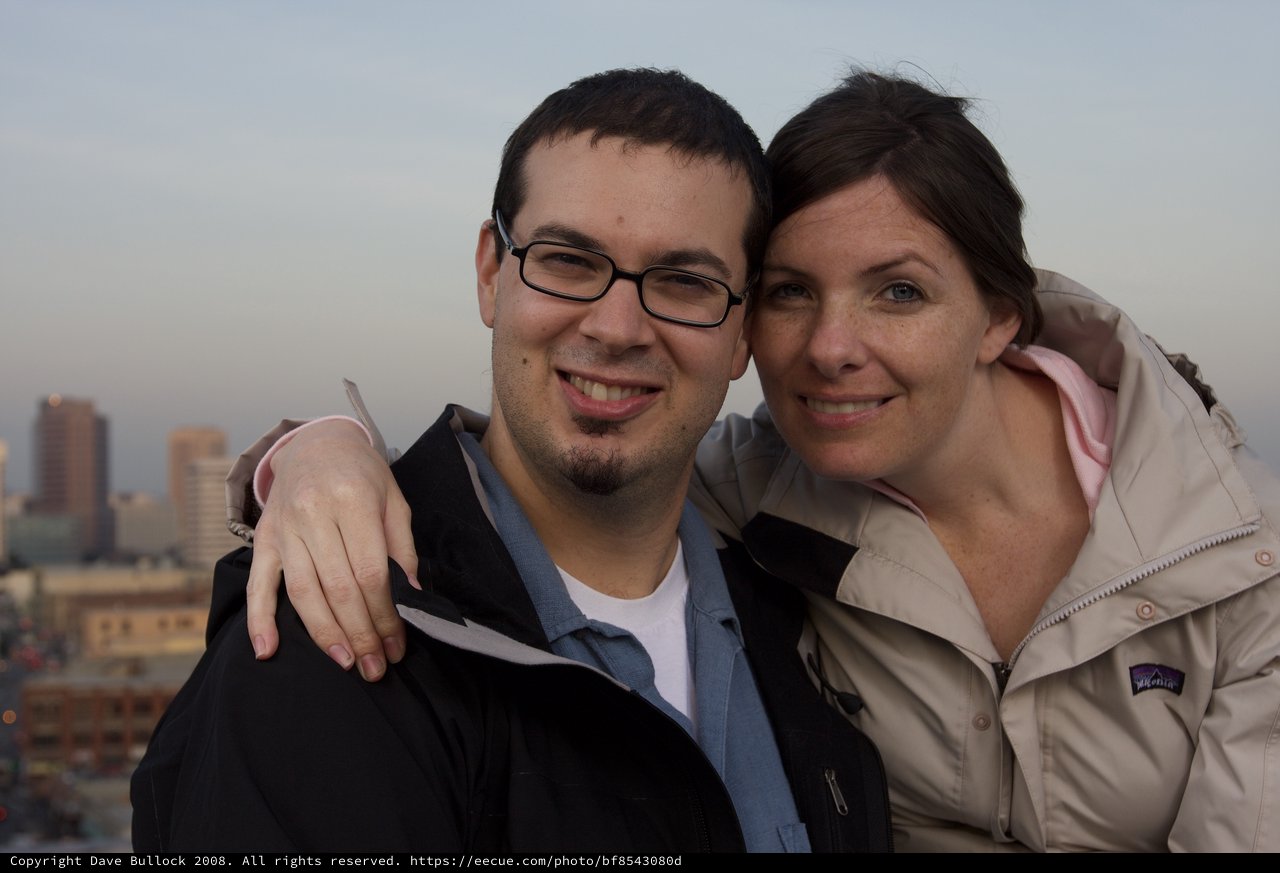 Couple Smiling Together Against City Skyline
