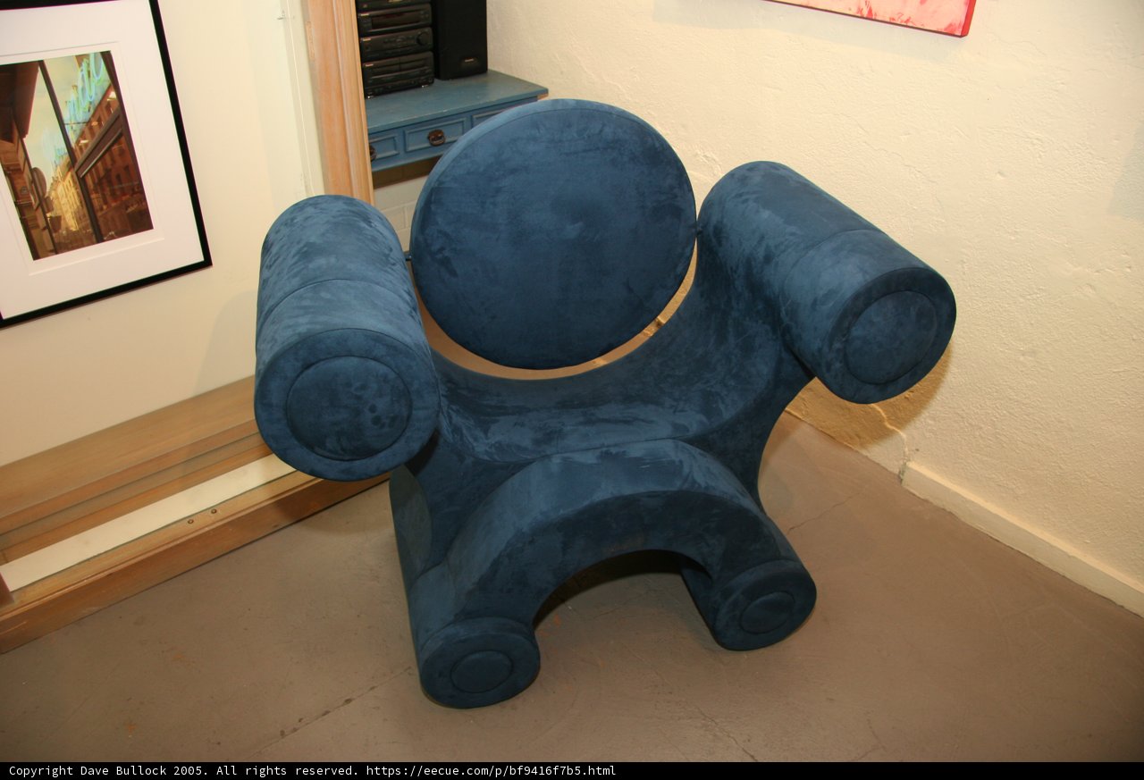 Blue Armchair in Art-Filled Room