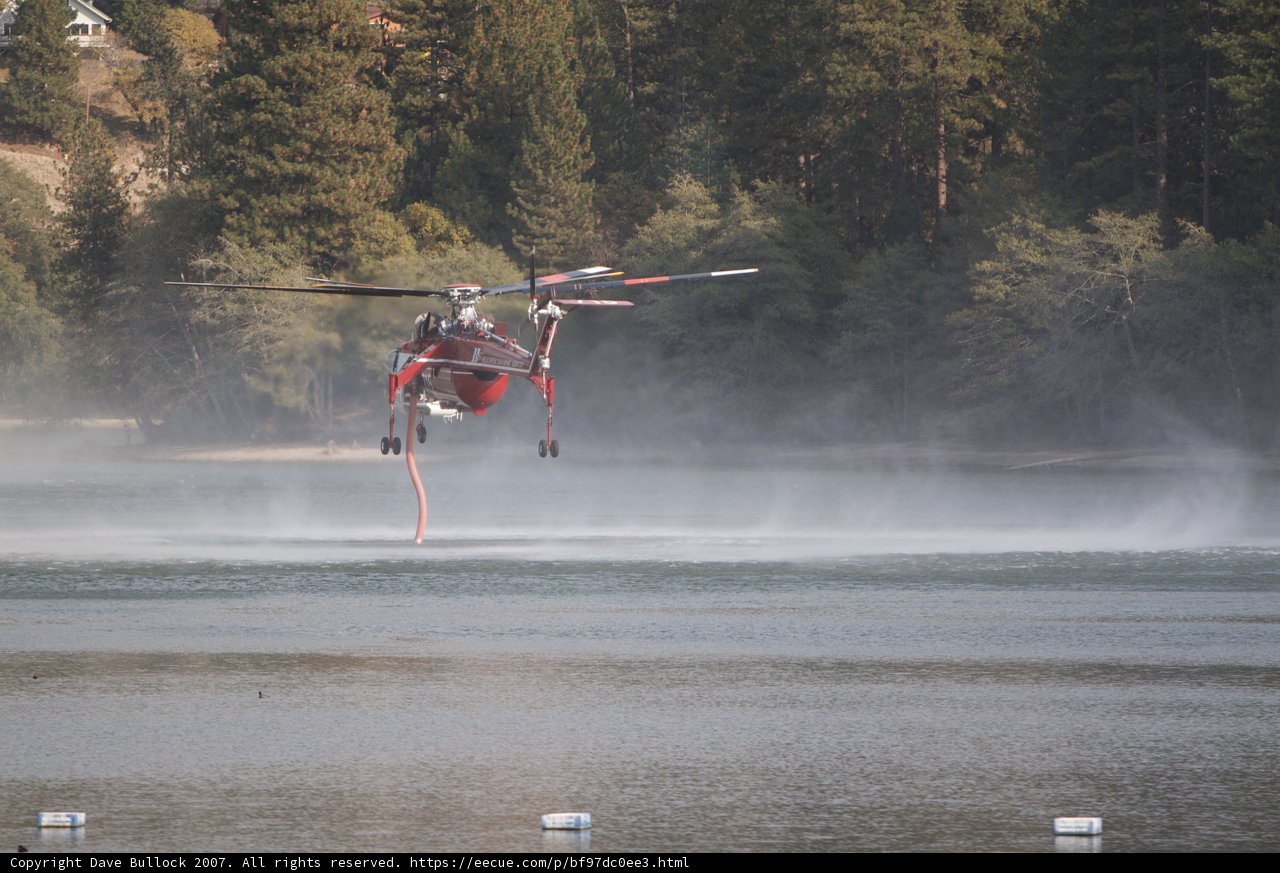 Helicopter Combatting Wildfires with Water Spray