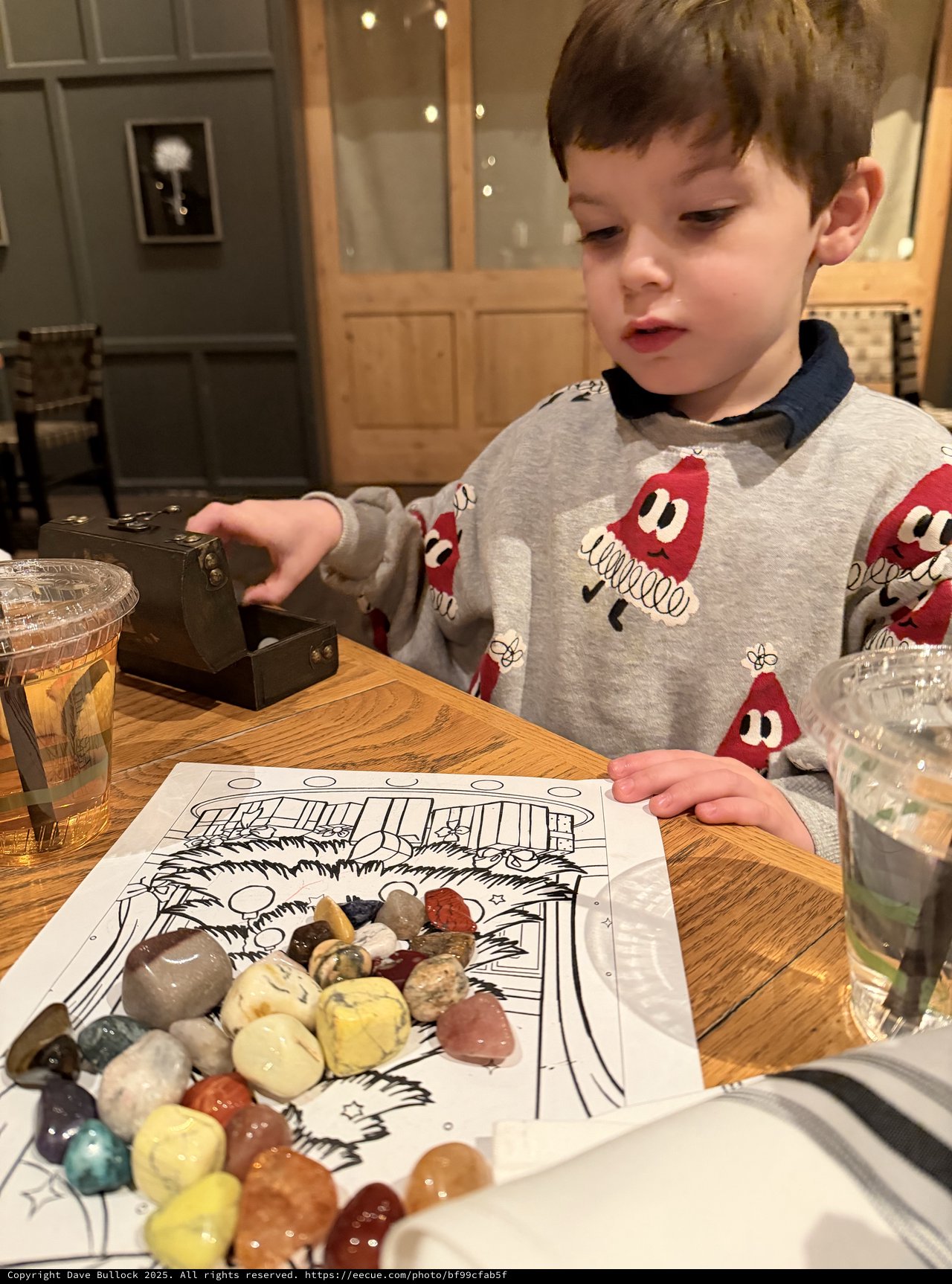 Young Boy Discovers Gemstone Treasure at Restaurant Table