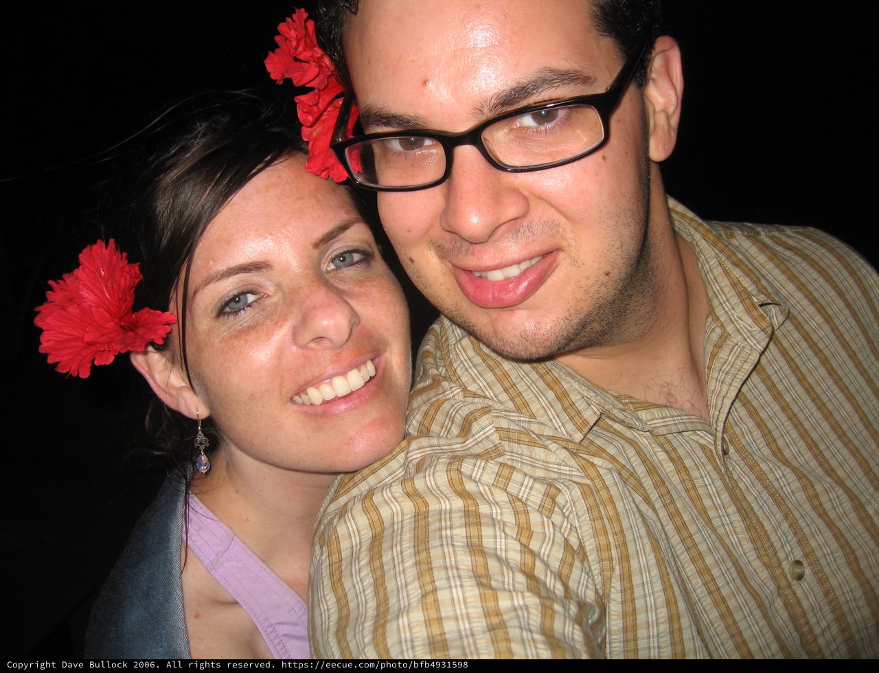 Happy Couple with Red Flowers at Evening Event