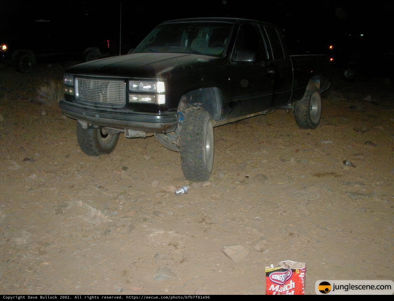 Black Pickup Truck parked in the Desert at Night