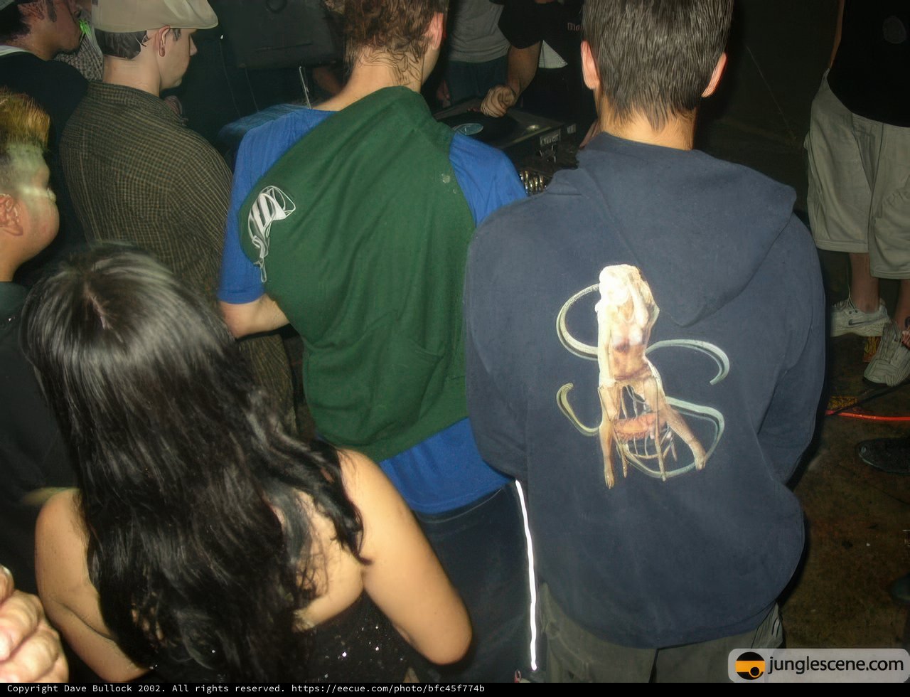 Group of People Surrounding Hoodie-Wearing Individual