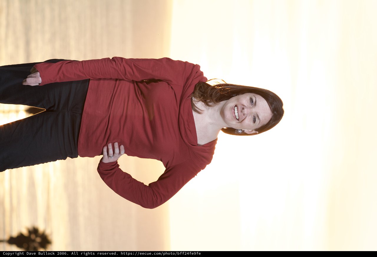 Woman in Red Smiling at Golden Ocean Sunset