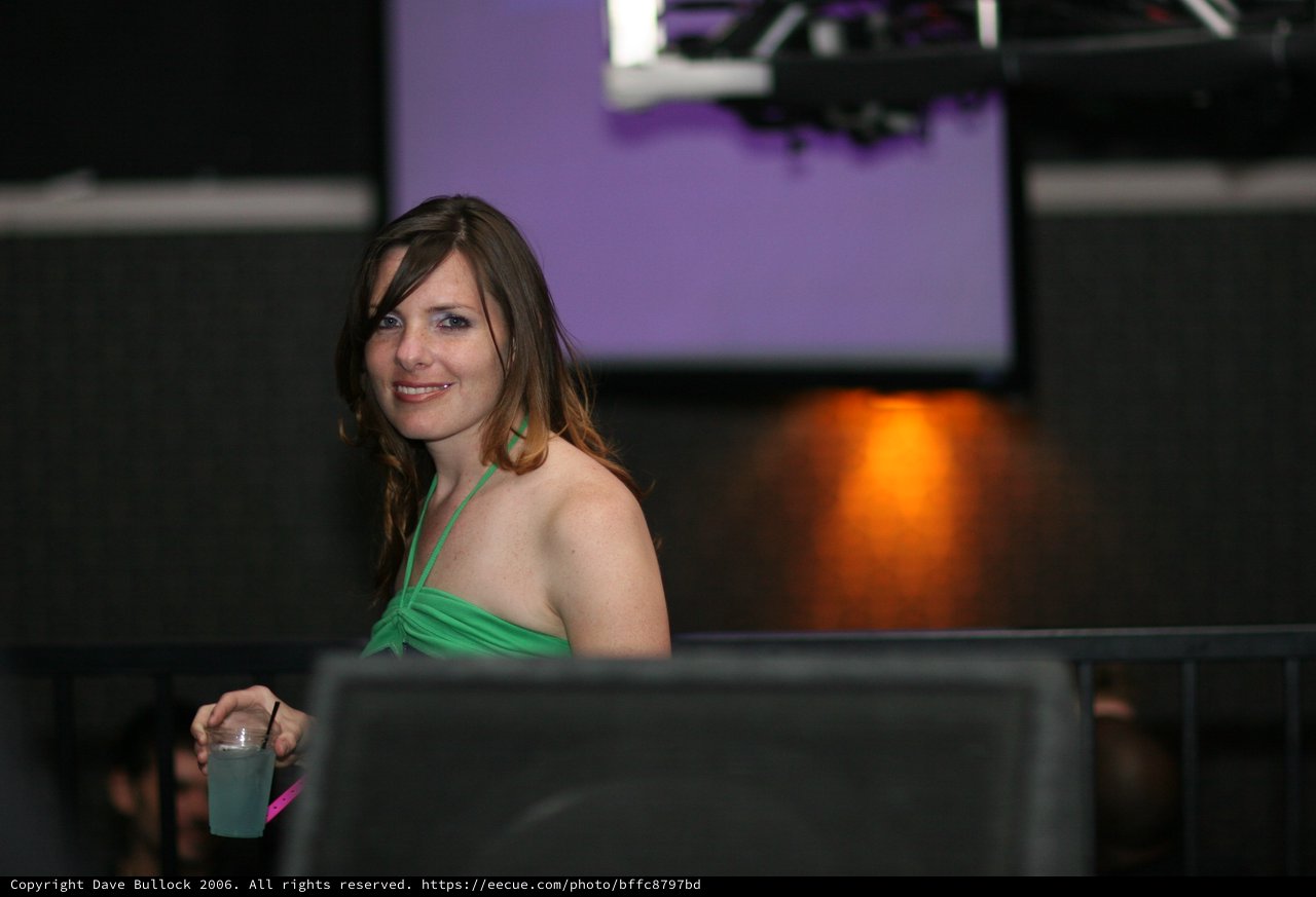 Woman in Green Smiling at Nightclub Event 2006