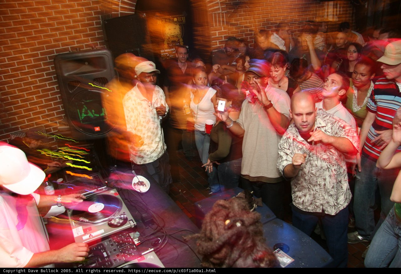 Nightclub Party with High Energy Crowd and DJ Equipment