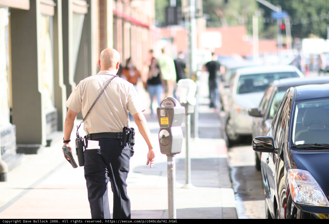A Man's Walk Amongst Cars and Furniture