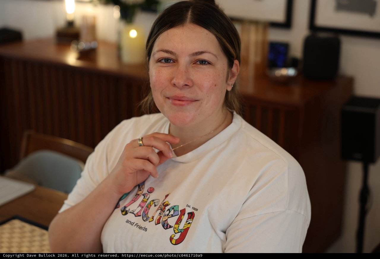 Woman in Colorful Graphic T-Shirt at Home