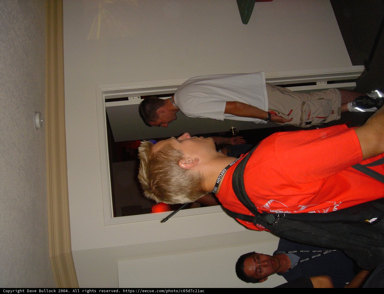 Red shirt man standing by the door