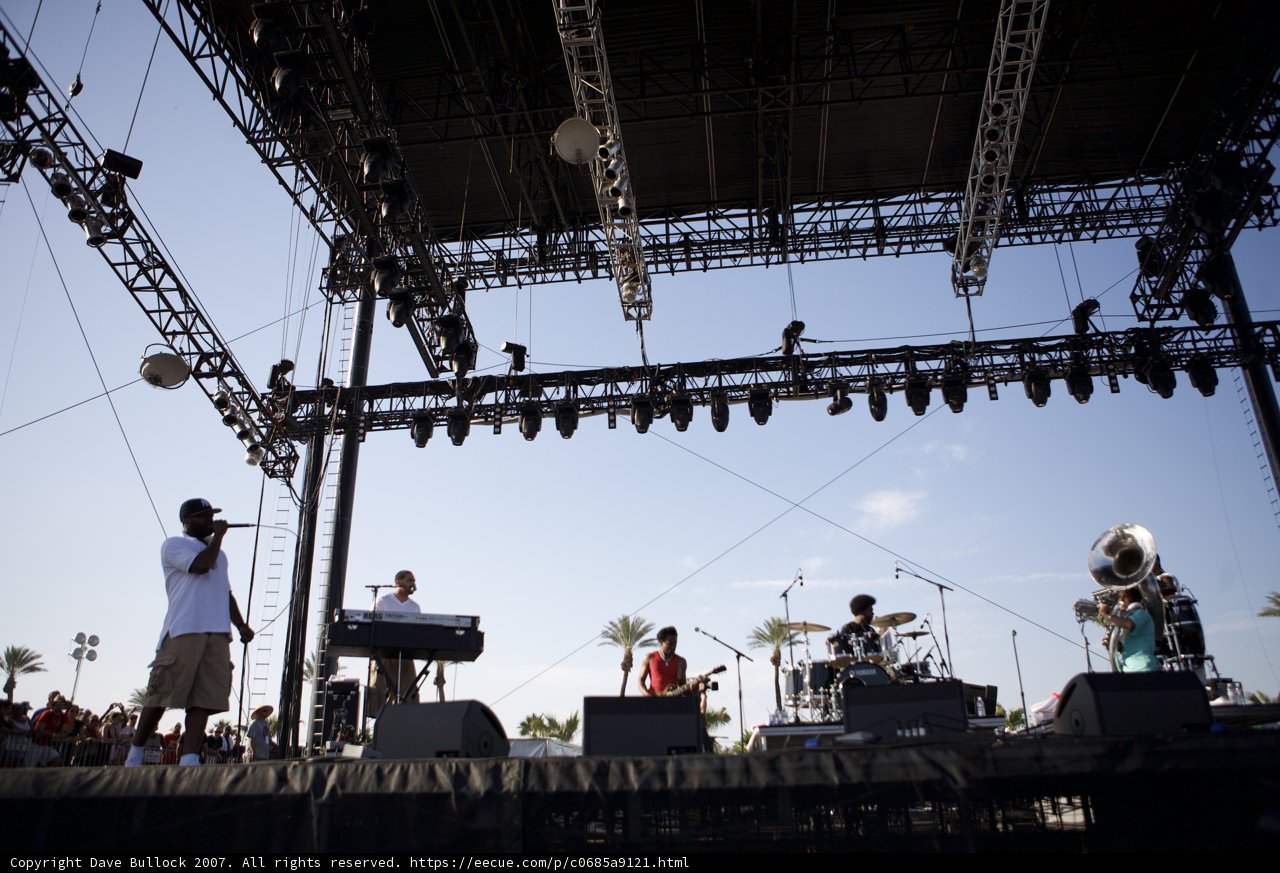 Band rocks music festival stage under the blue sky