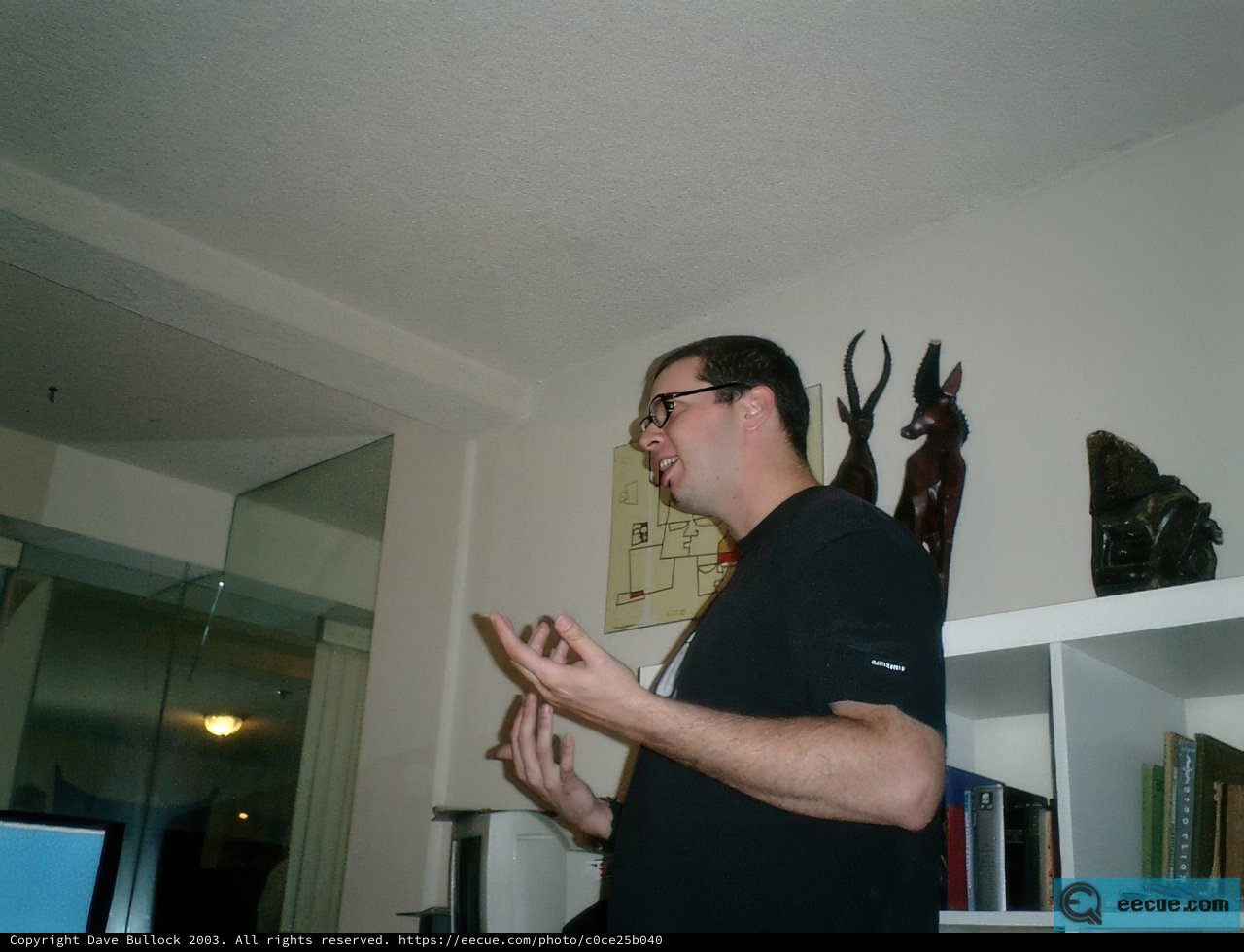 Man Standing in Front of Shelf