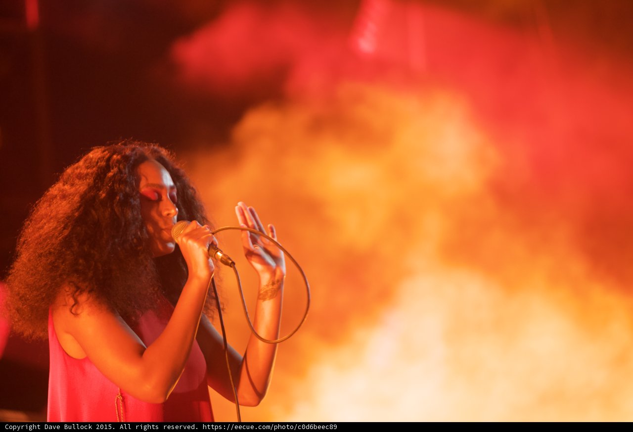 Solange Portrait Hand Raised Fingers Spread Expressive Orange Smoke