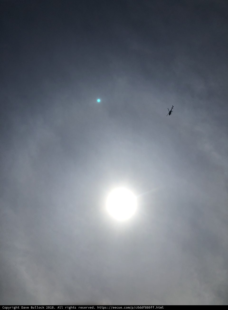 Haloed Plane in Midday Sky