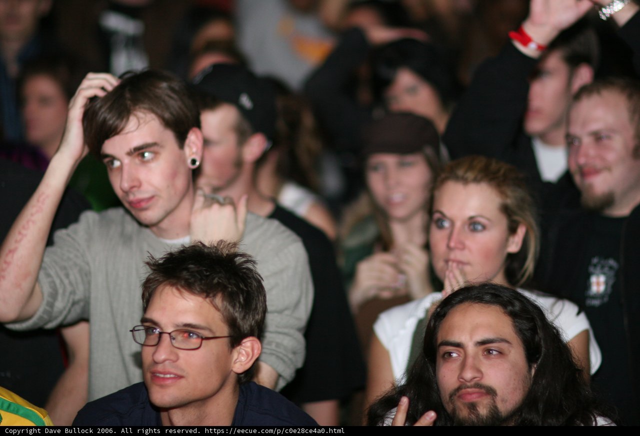 Grey-shirted man among a lively crowd