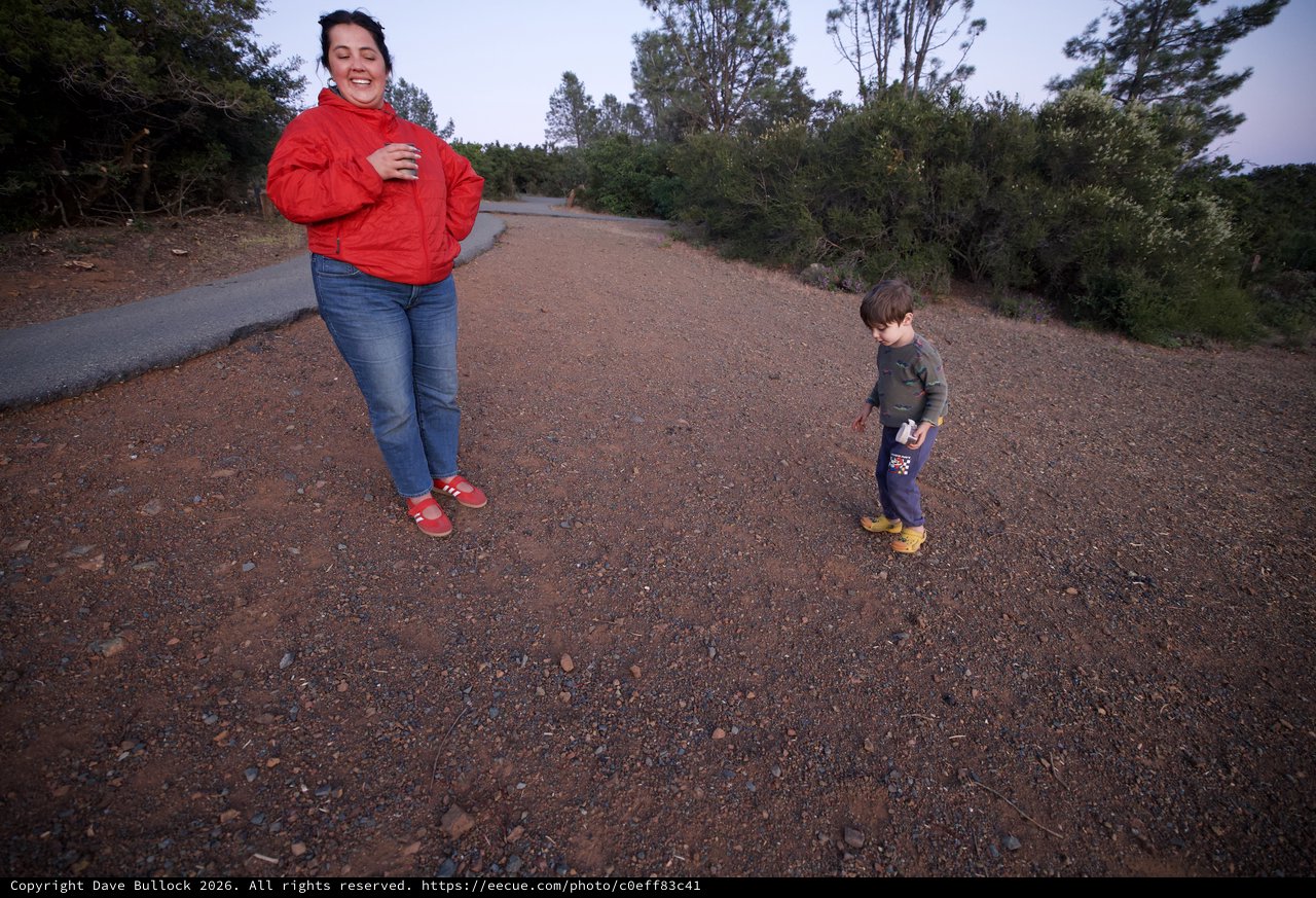 Mother and Child Laughing on Dusty Trail Path