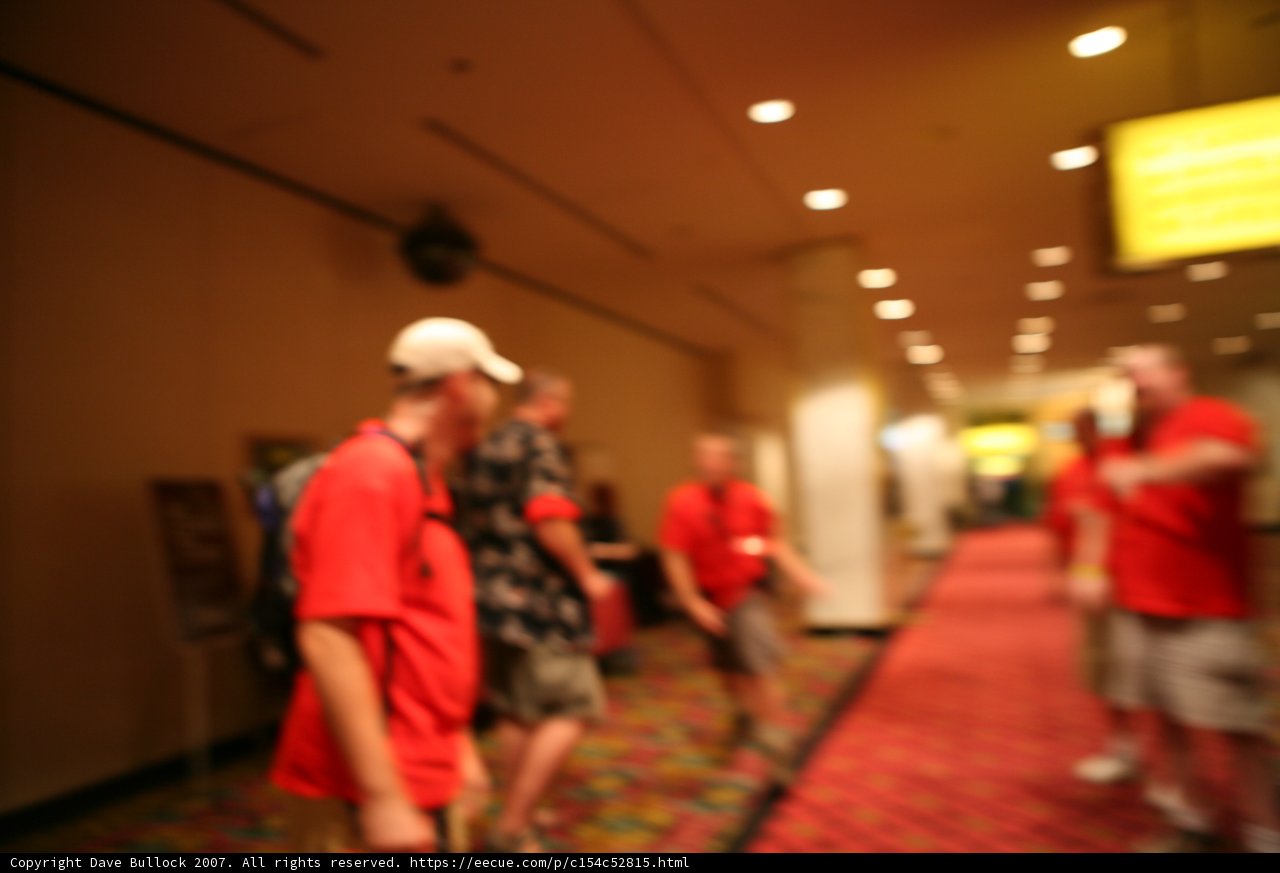 Blurry Group Walks Down Hallway
