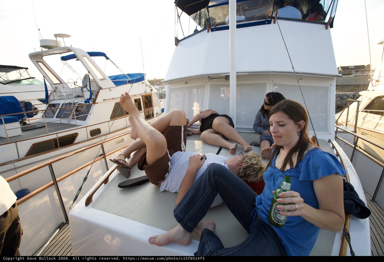 Friends Relaxing on Yacht Deck at Marina