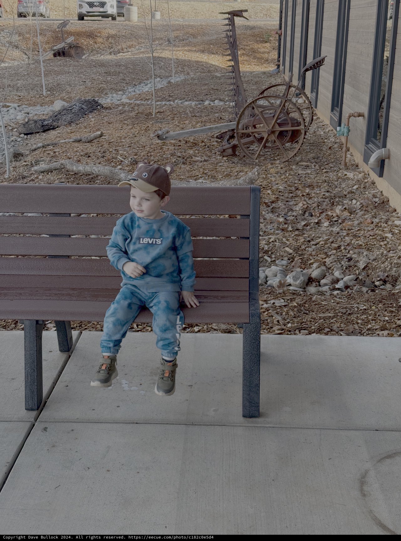 Young Child Sitting on Bench at Museum