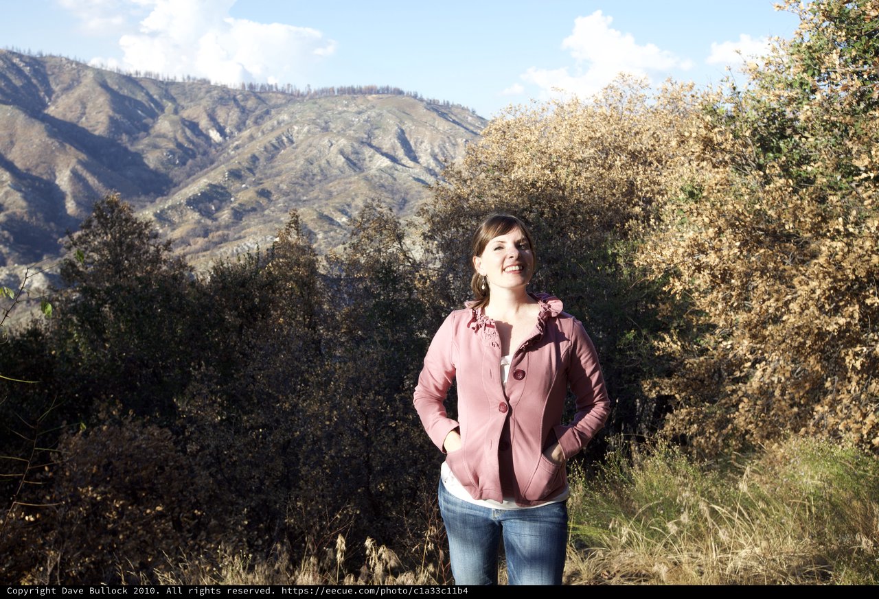 Joyful Woman Smiling in Mountain Wilderness Setting