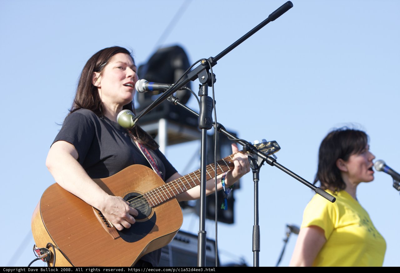 Kim Deal strums her guitar under the bright blue sky at Coachella
