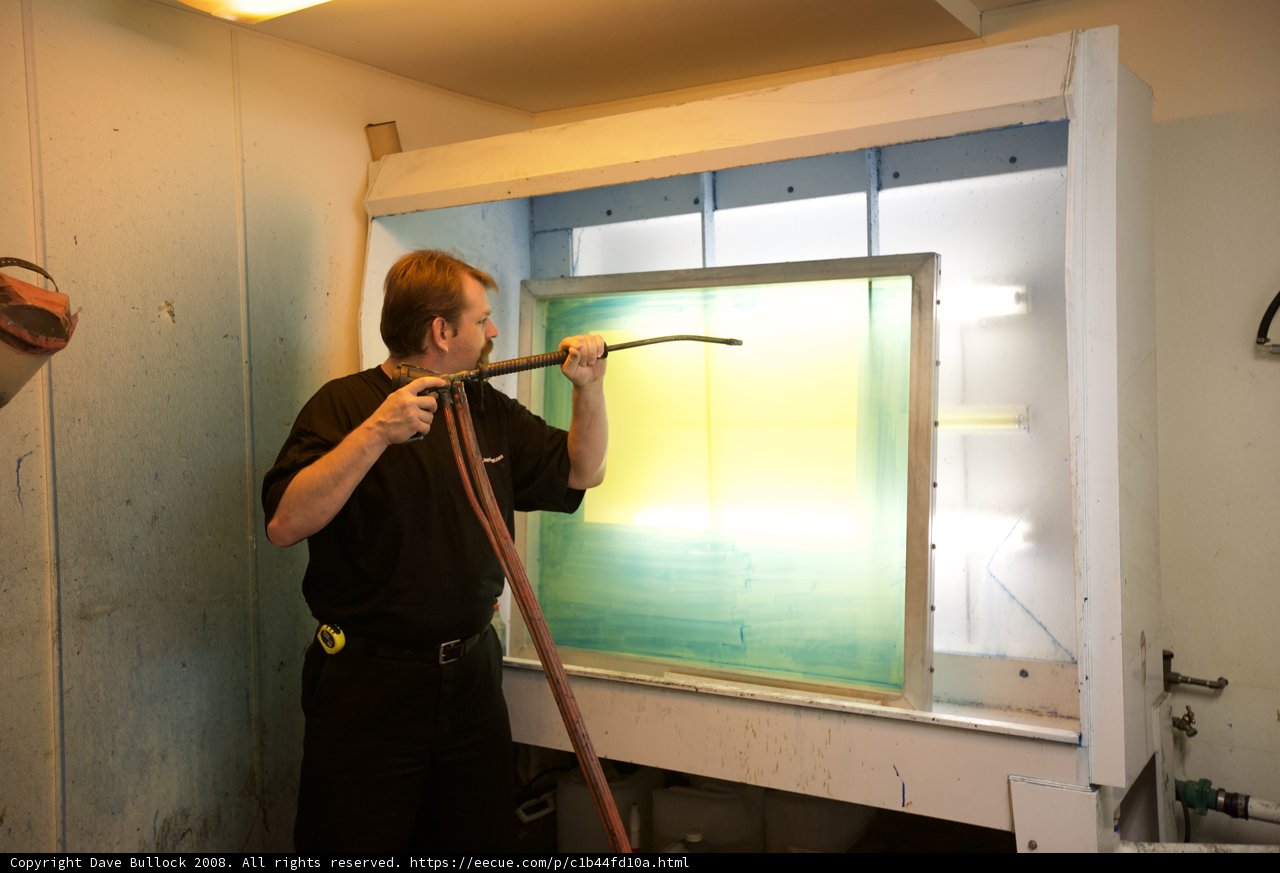 A Man at Work Painting a Window