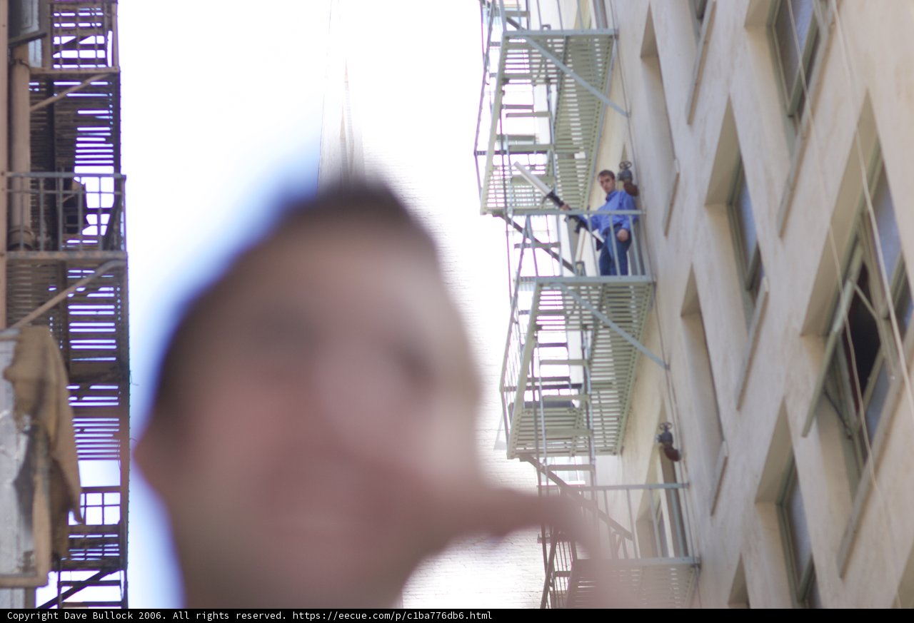 Man on a Balcony in the City
