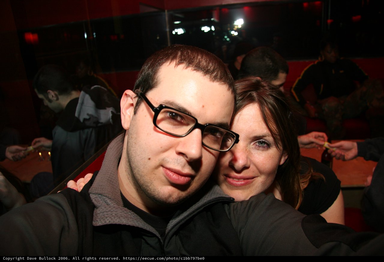 Two Friends Pose Close at Nightclub Event