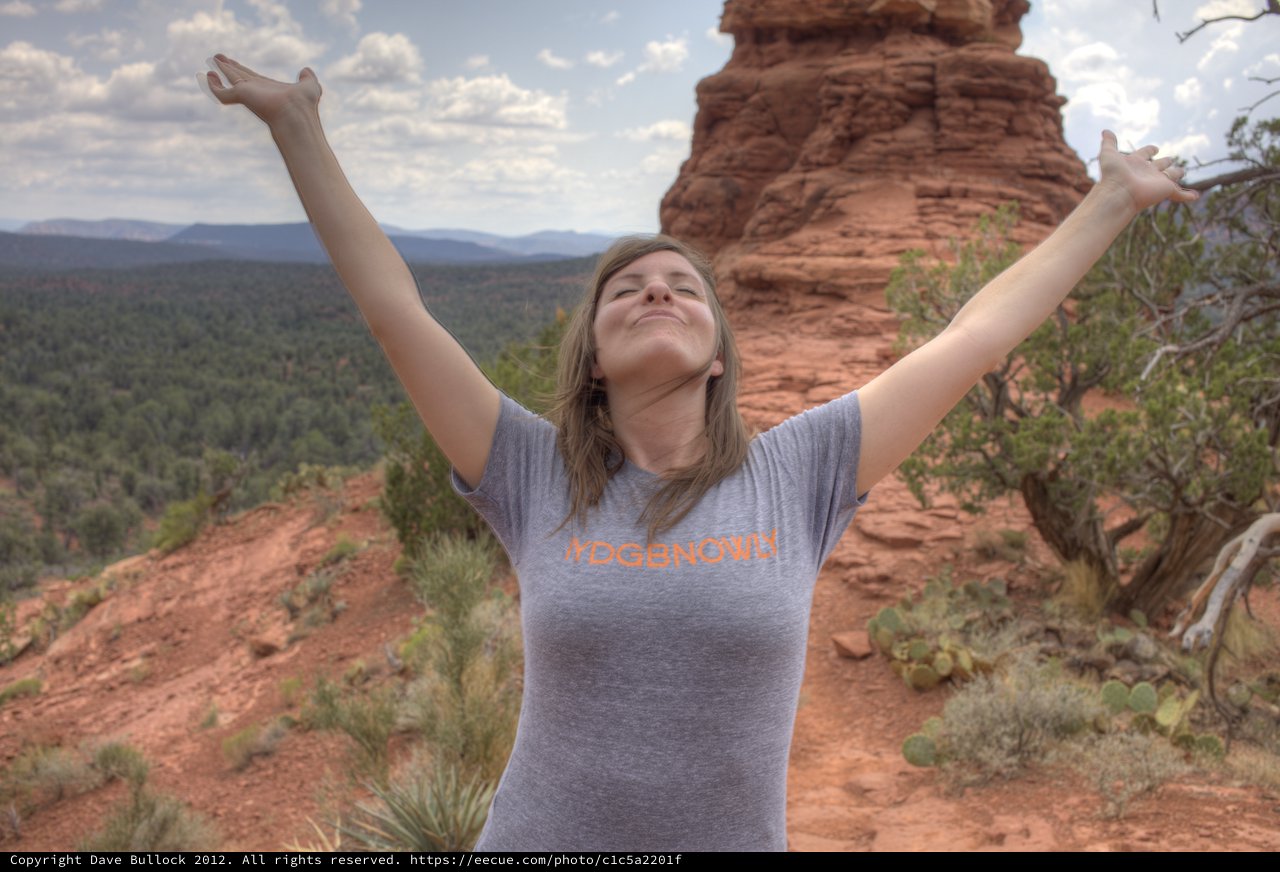 Joyful Woman Embracing Freedom Atop Sedona Red Rocks