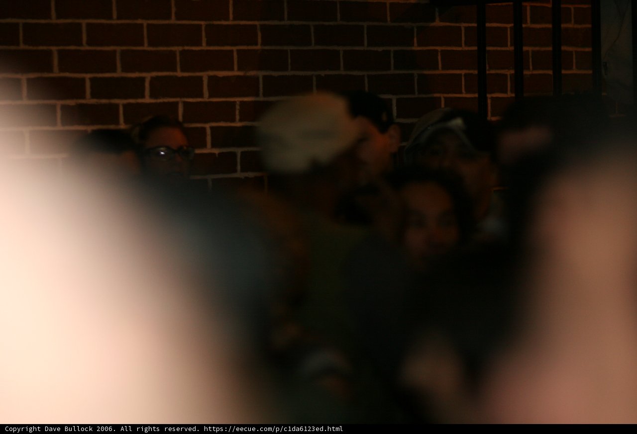 Blurry Crowd at Brick Wall