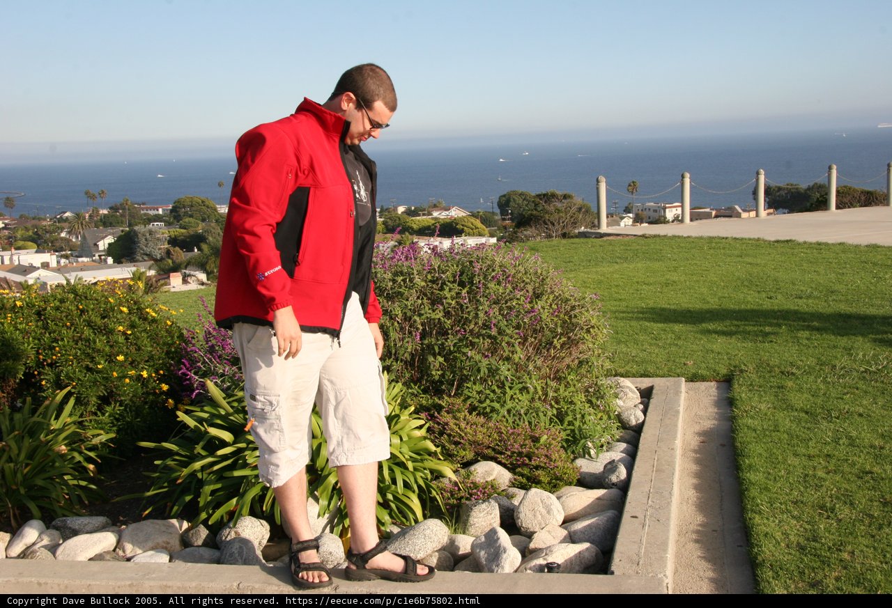 The Red Jacketed Man on the Rock