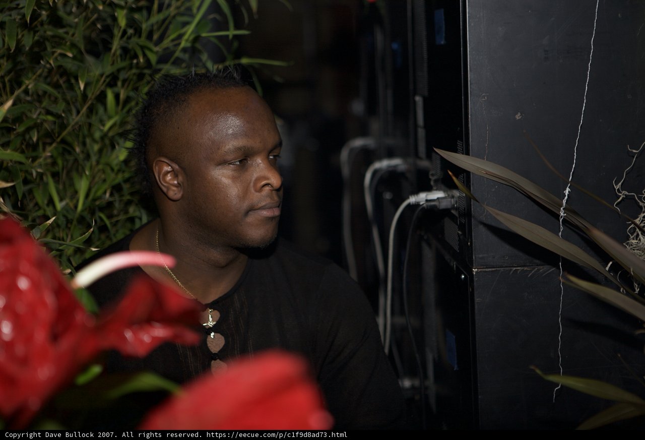 DJ SS sits among flower arrangements