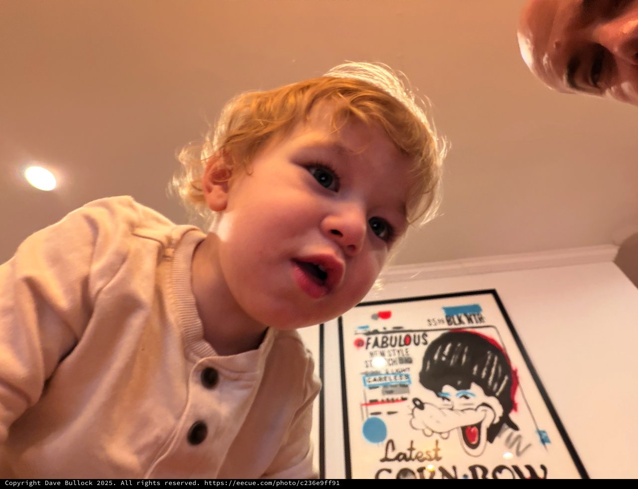 Toddler's Excited Expression Over Colorful Comic Book